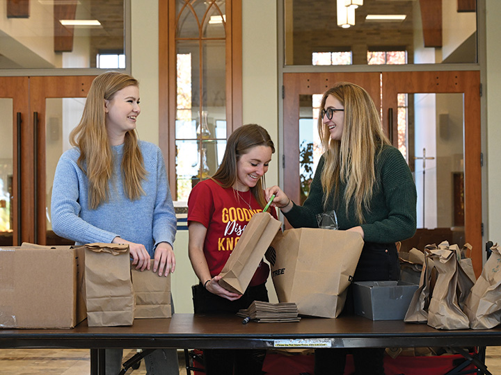 Students pack bags for a community service project.