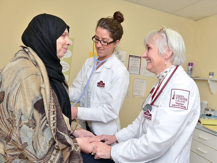 A nursing student provides care to a resident of St. Joseph's Neighborhood Center under the guidance of a faculty mentor.