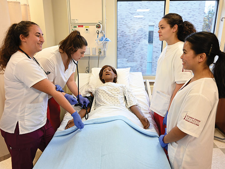 Nursing students participate in a simulation.
