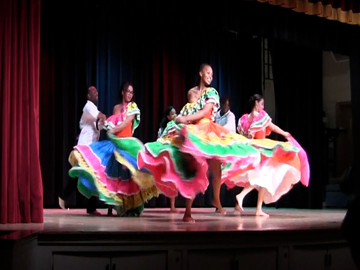 Dancers perform in colorful attire as part of Spirit of Identity Week.