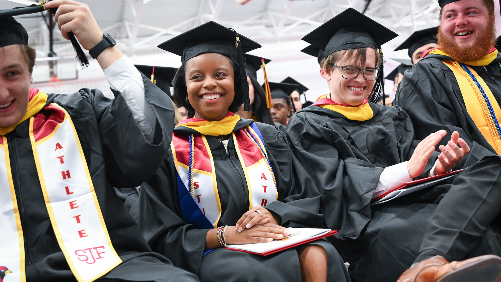 Students turn their tassels and clap during a Fisher Commencement Ceremony.