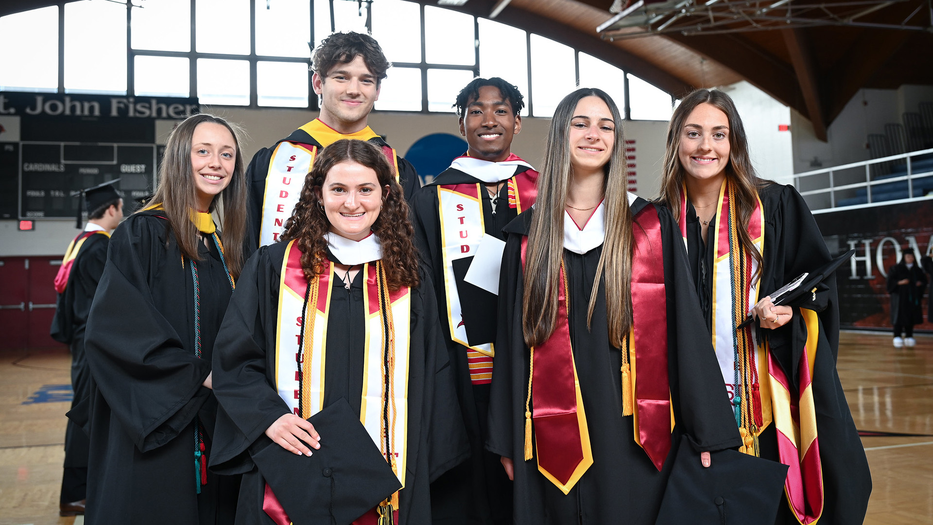 A group of graduating students in Commencement regalia.