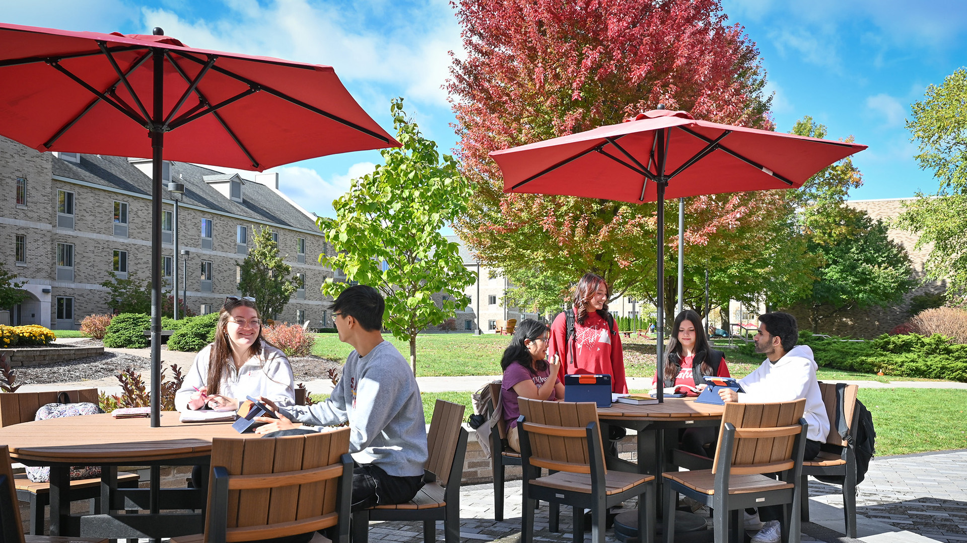 Students enjoy the Terrace at Tepas Commons on campus at St. John Fisher University in the fall.