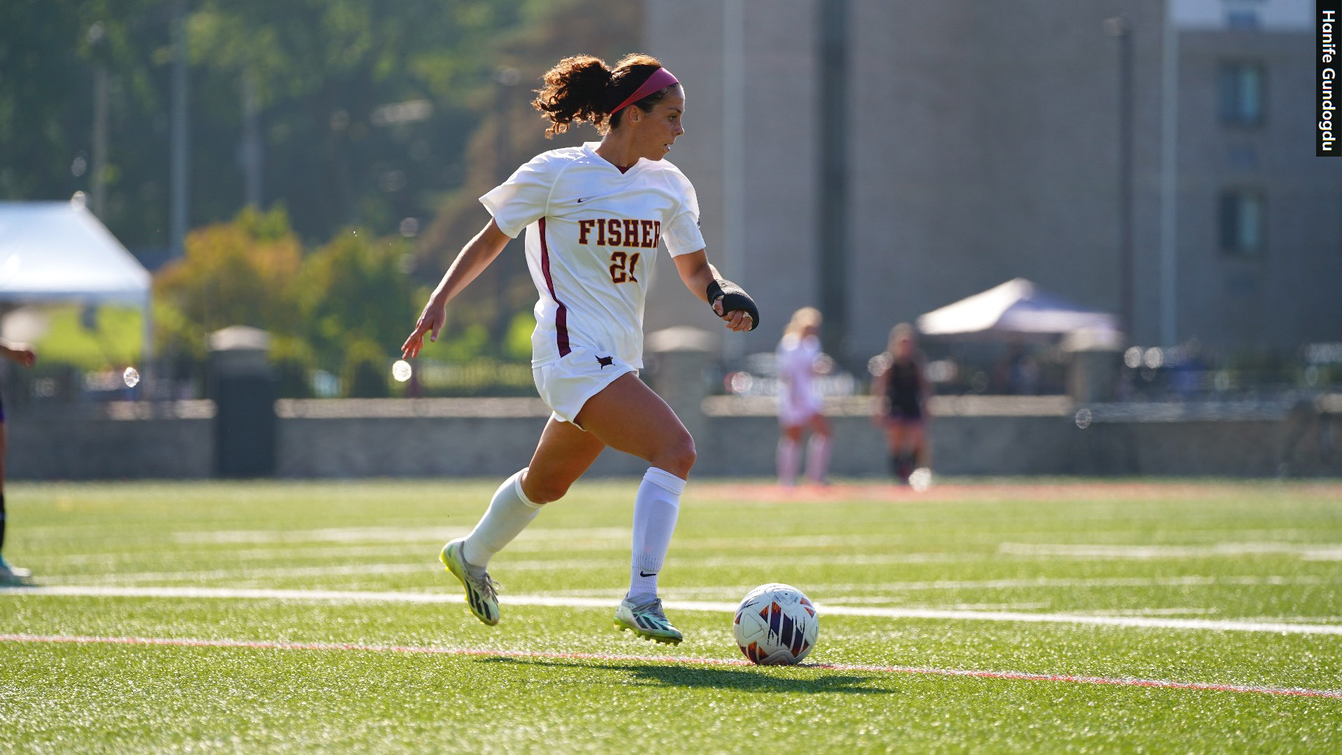 A soccer player kicks the ball toward the goal.