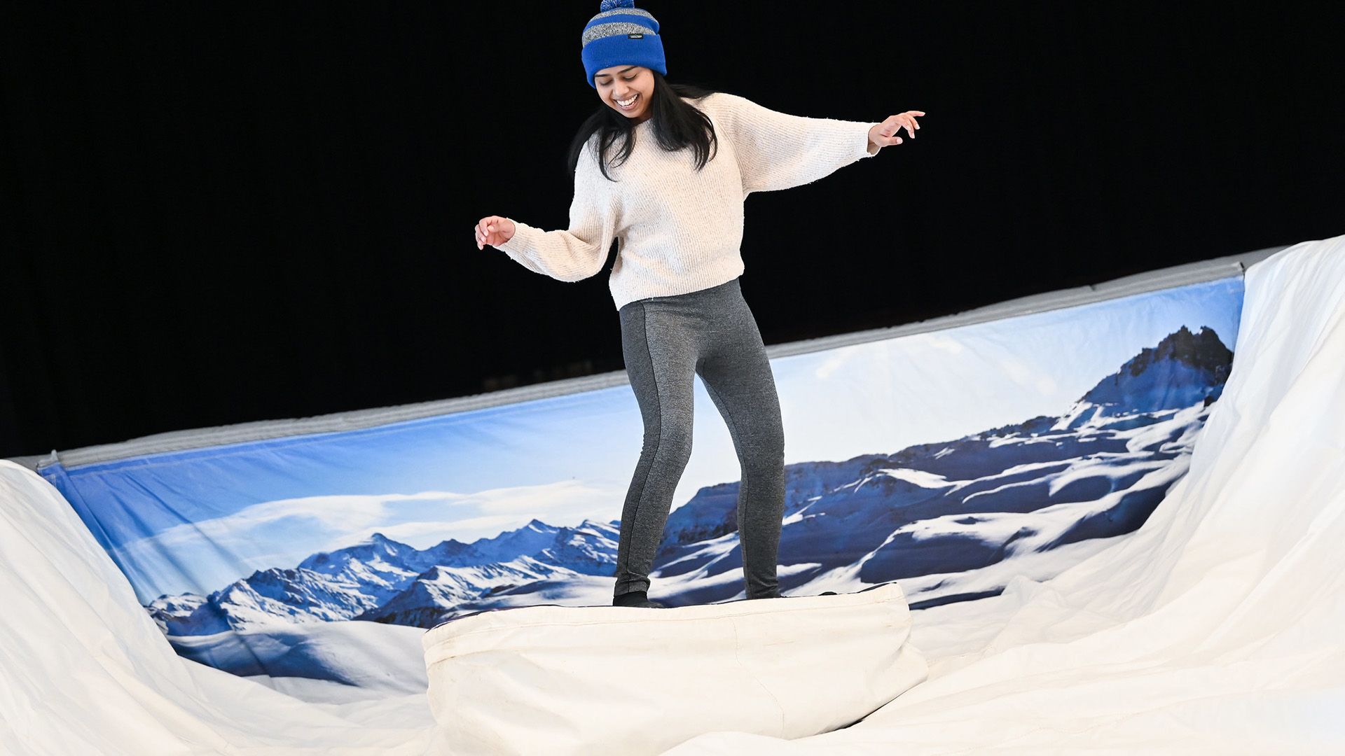 A student stands on a mechanical surf board during an event at St. John Fisher University.
