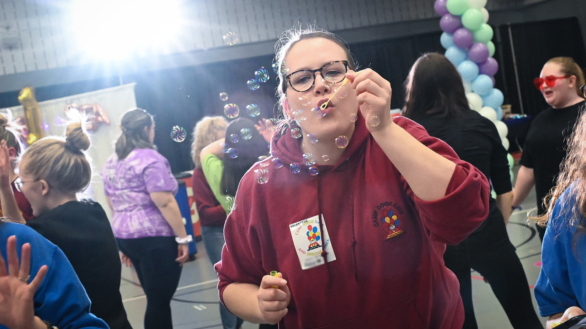 A student blowing bubbles at the Teddi Dance for Love.