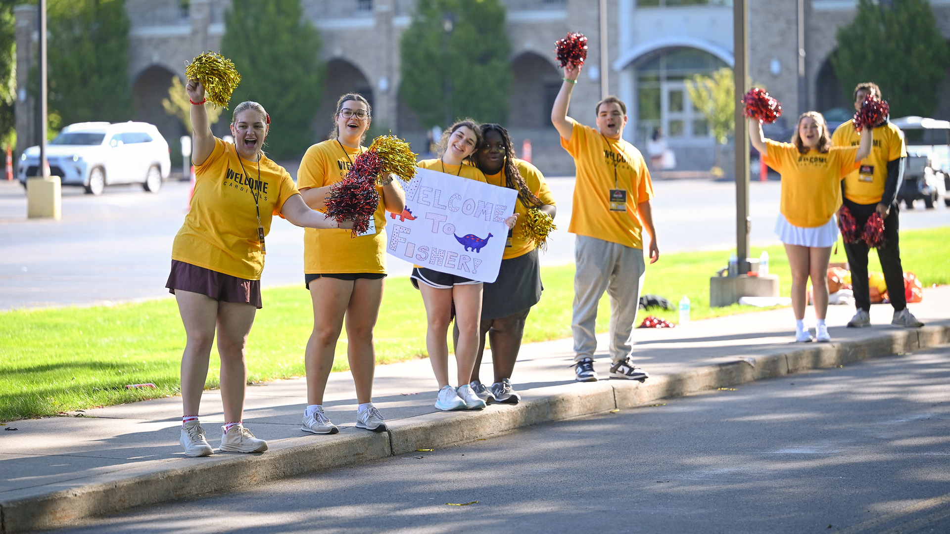 Students welcome the incoming class to Fisher with welcome signs and pom poms.