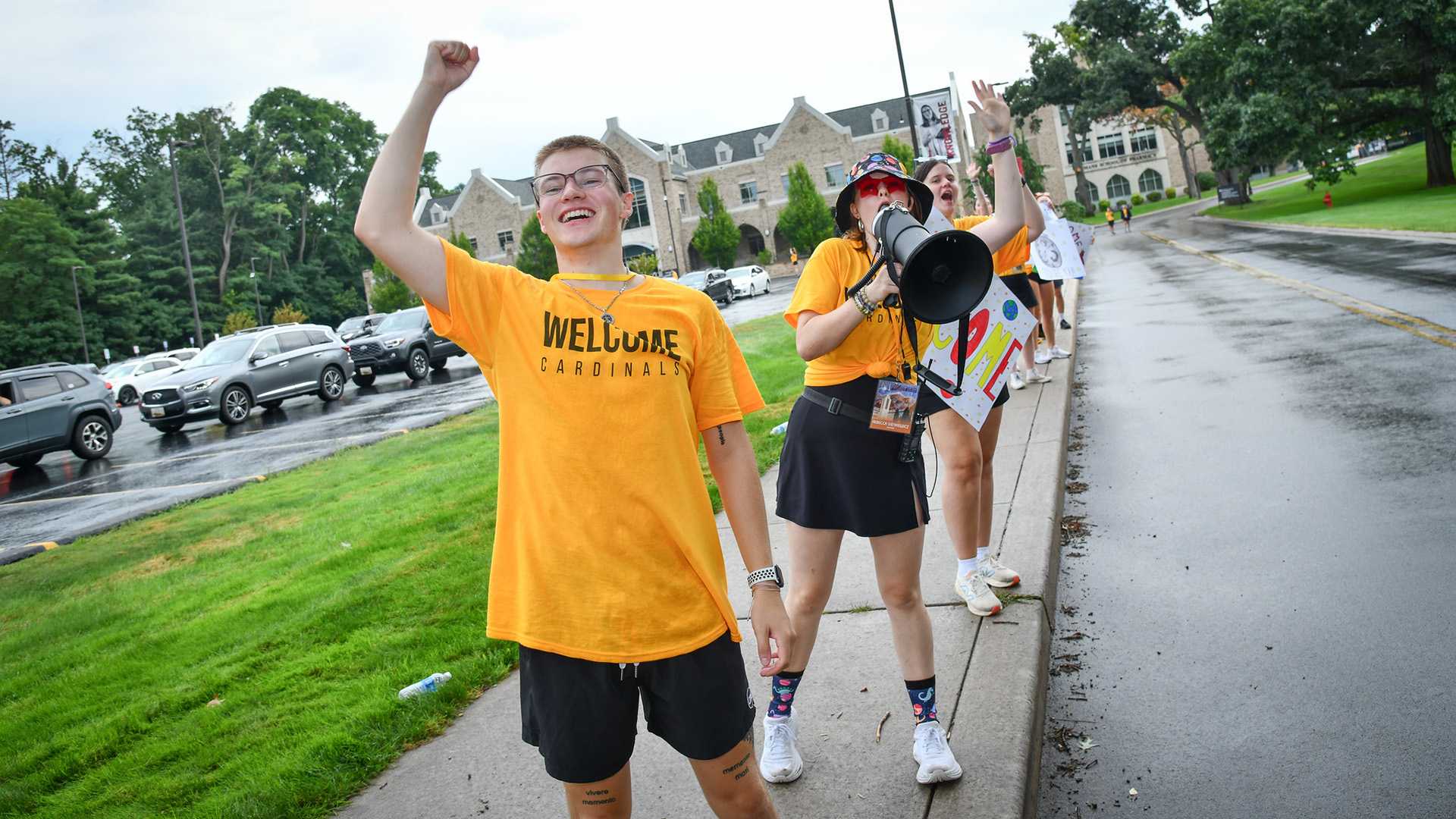 Group of students welcoming visitors and new students to campus celebrating Fisher as a home away from home.