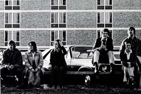 A group of six students sitting atop a car in 1975