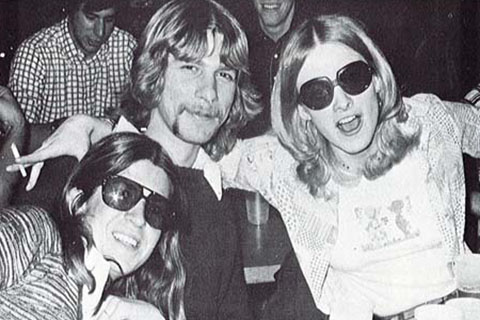 Black and white photo of three students smiling