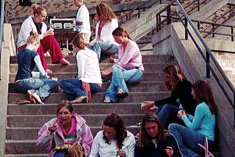 2005 students relaxing and sharing a meal on the library stairs