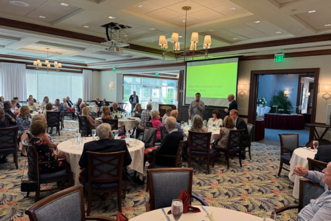 Alumni seated at tables during a dinner in Naples, Florida