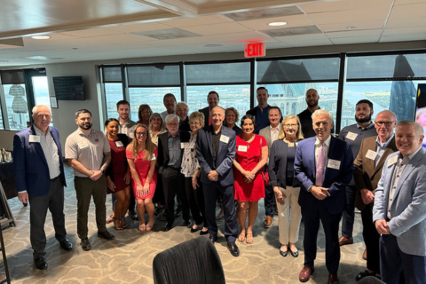 Alumni gather for a group photo at a reception in Tampa
