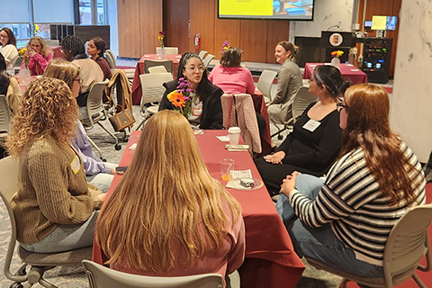 Students, alumni, and employees engage in conversation during the 2025 Alumni World Cafe event.