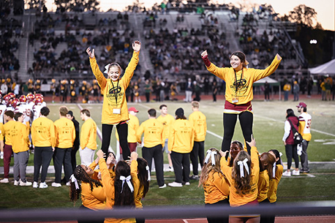 Honorary cheerleaders showing off their moves with the Fisher cheerleading team.