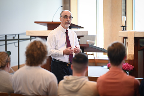 A speaker gives a lecture in the Hermance Family Chapel of St. Basil the Great.
