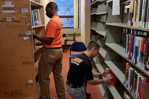 Movers remove books from shelves at Lavery Library.
