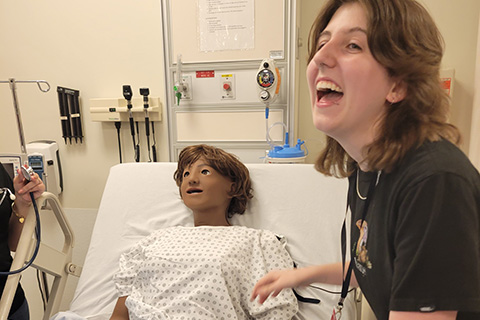 A student practices nursing skills in a simulation space.