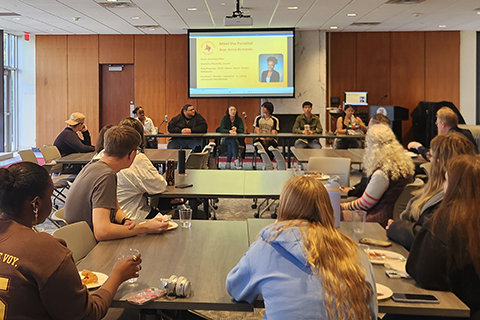 Members of the campus community listen as a panel of first-generation students talk about their experiences.