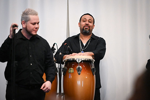 Singer and drummer from Panloco Steel Drum Band performing.