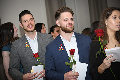 Graduating nursing students wearing their Fisher pins from the pinning ceremony.