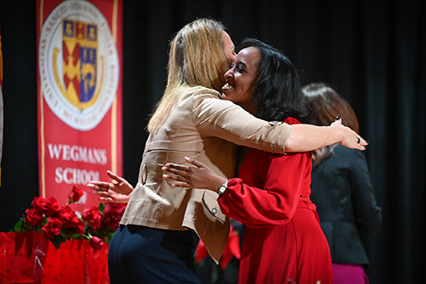 Dr. Christine Boev hugs a graduating nursing student.