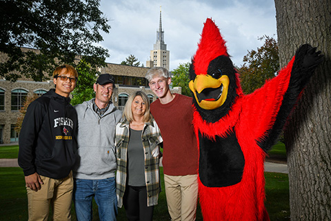 Family portraits with Fisher's Cardinal mascot during Family Weekend.