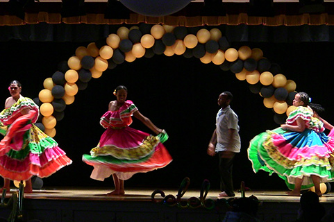 Dancers perform on stage during Spirit of Identity Week at Fisher.