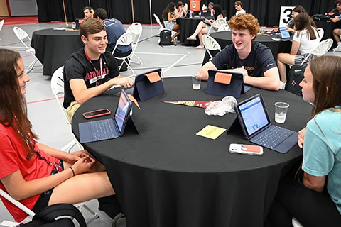 A group of students explore their iPads during Great Beginnings orientation.