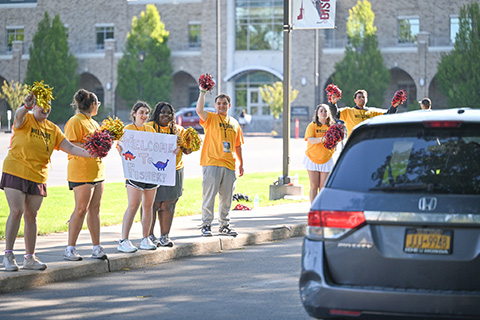 Orientation team members greeting new students as they arrive on campus.