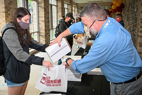Students receive their iPads in an iFisher Next Generation Learning Initiative bag.