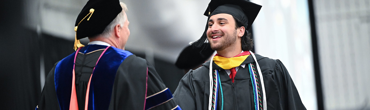 An adult student celebrates finishing his degree.