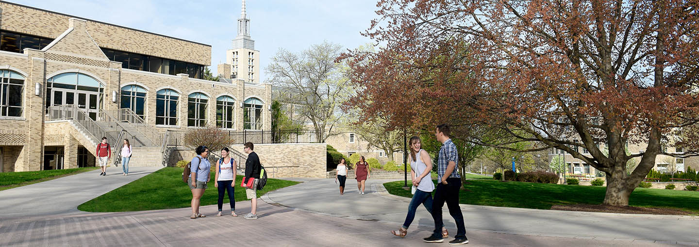 Several groups of students walk through LeChase Commons.