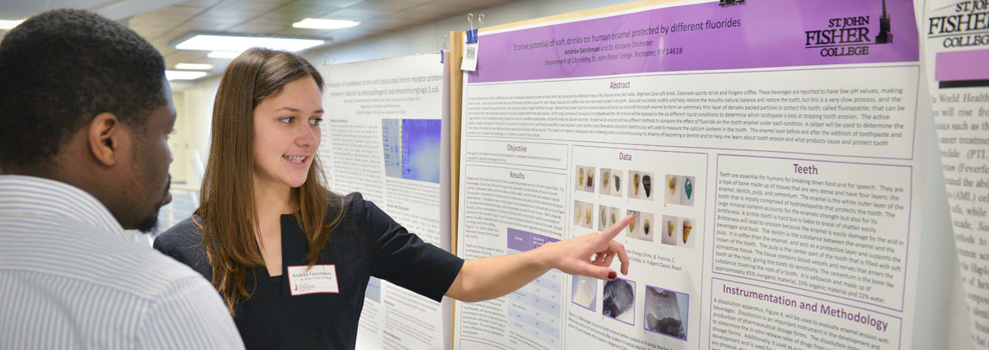 Student pointing to science research poster.