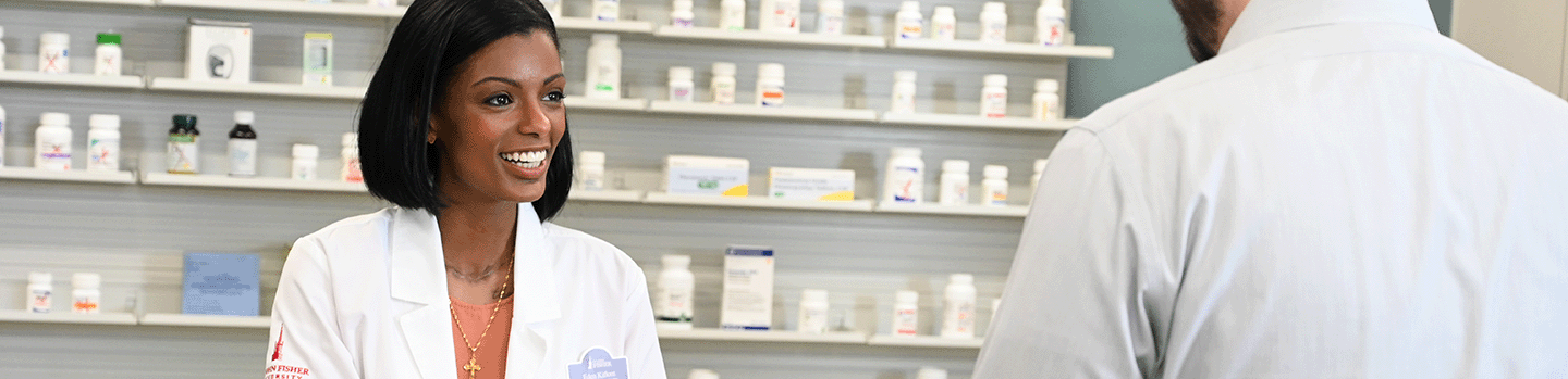 A pharmacy student practices dispensing medications.