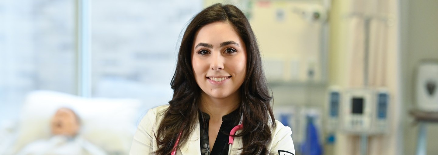 Nursing student with smile in simulation room