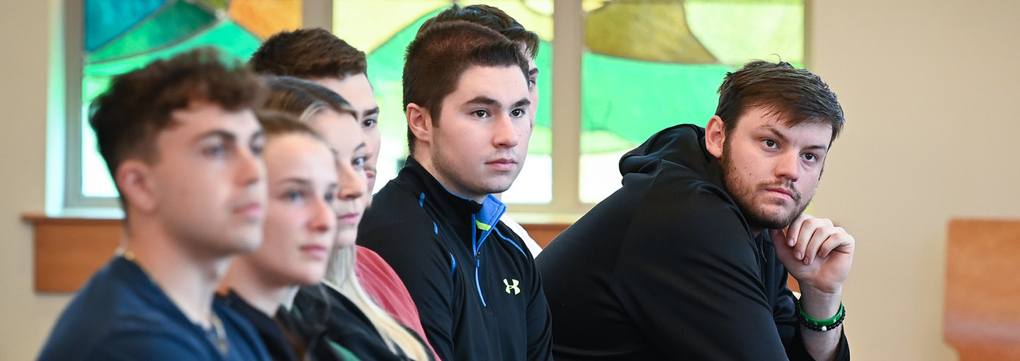 Group of students gather in chapel.
