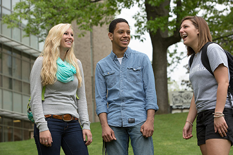 Students laughing together on campus.