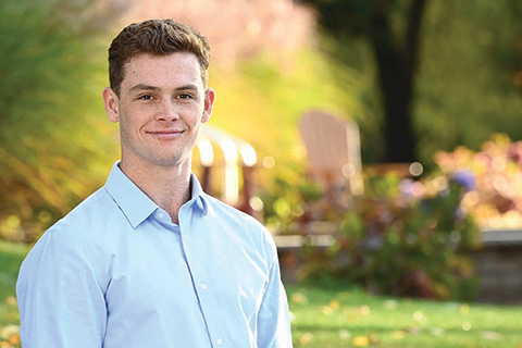 A business student stands confidently.