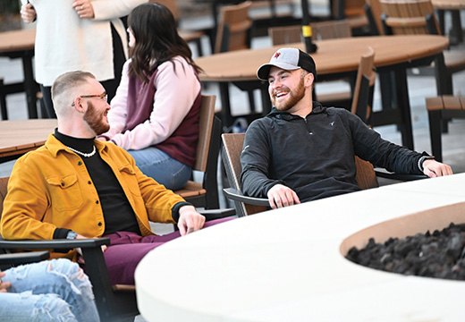 Students sit together on St. John Fisher University campus.