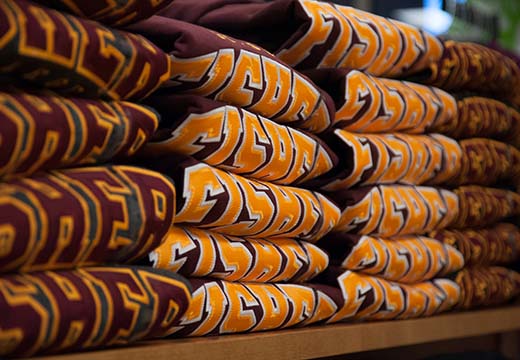 Fisher sweatshirts folded at College Store.