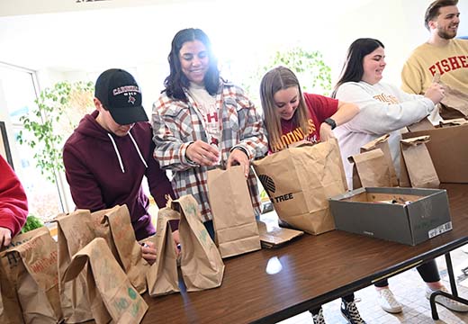 Student pack bags for community service project.