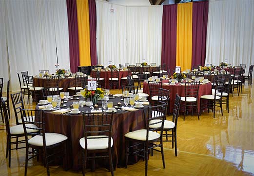 Tables set up for an event in the Varsity Gym.