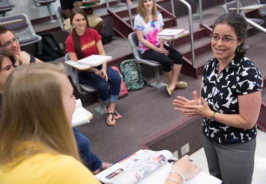 Professor Deb Uman speaks in front of class.