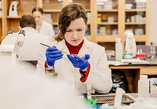 A student conducts an experiment in a chemistry lab.