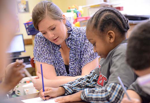 Student teacher working with elementary students