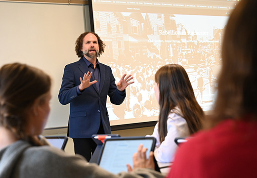 A professor teaches a history class at St. John Fisher University.