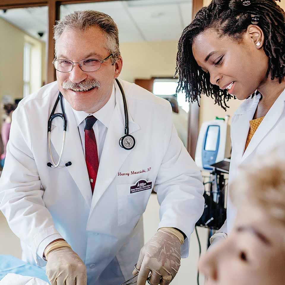 Graduate health nursing students practice in the simulation lab.